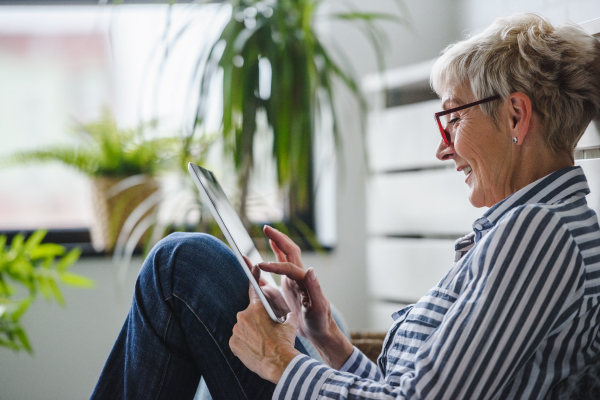 Older Adult Woman Using Digital Tablet at Home