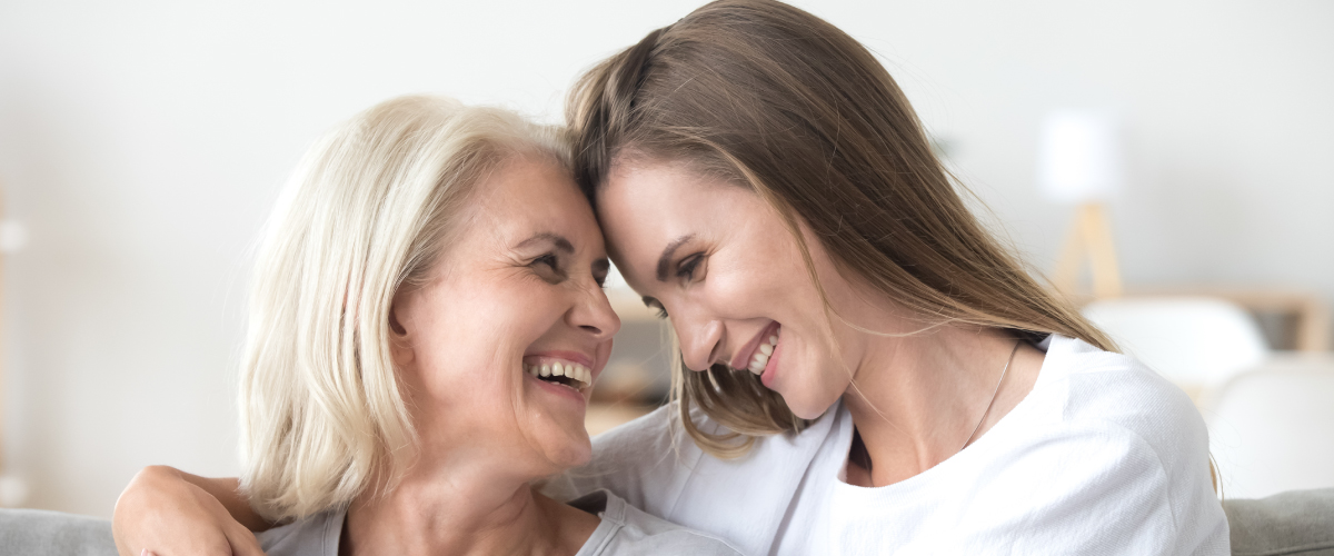 Older Adult Woman Embracing Younger Woman