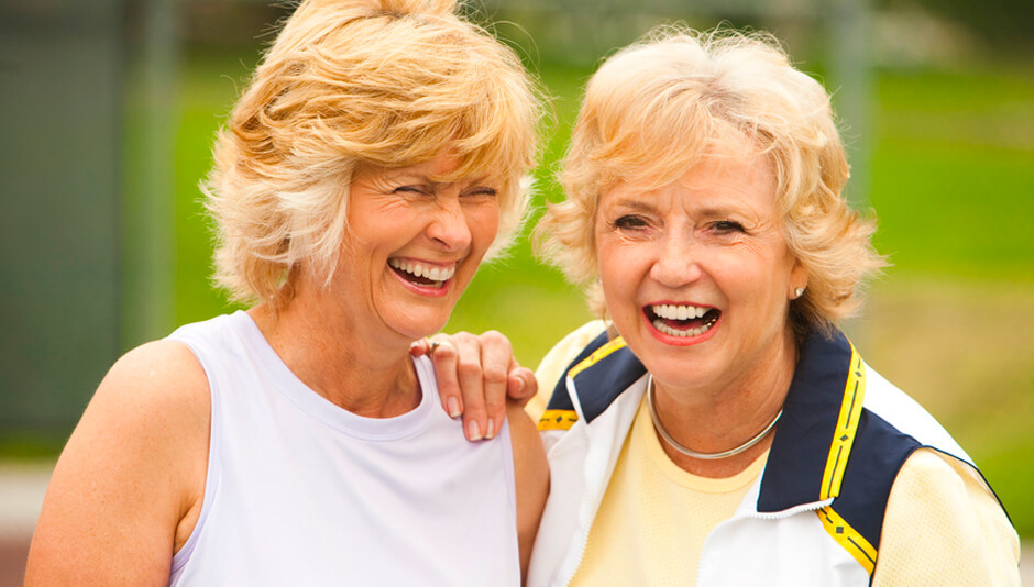 Two Older Adult Women Smiling and Laughing