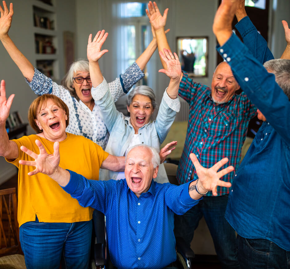 6 Older Adults Smiling and Laughing with Arms Raised